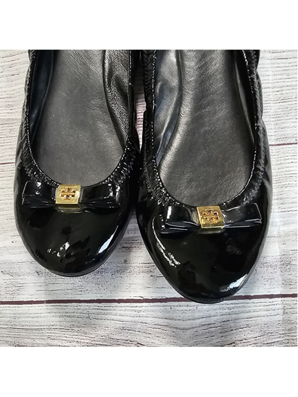 Tory Burch 10M shiny black ballerina flats with black and gold bow accent